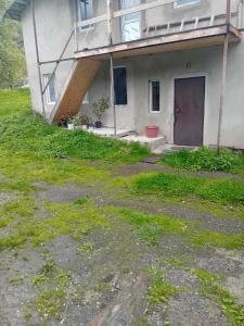 an abandoned house with a ramp up to a balcony at Jemal Guest House in Cholashi