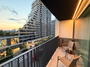 a balcony with two chairs and a building at Belgrade Waterfront Penthouse 17th last floor in Belgrade