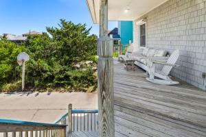 a porch with chairs and a bench on a house at 8396 - White Dune in Avon
