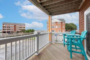 a balcony with two chairs and a view of the water at SBC1001 - Sweet Retreat in Manteo