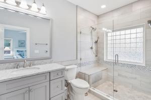 a white bathroom with a toilet and a shower at SBC1001 - Sweet Retreat in Manteo