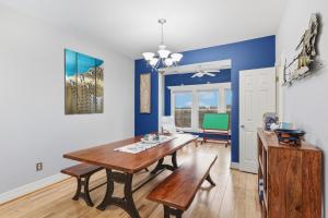 a dining room with a wooden table and blue walls at SBC1001 - Sweet Retreat in Manteo