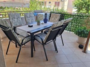 a dining table and chairs on a patio at Sirena House in Limenaria