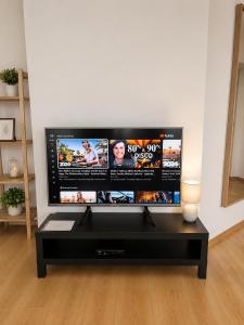 a flat screen tv sitting in a living room at APARTMENT ON THE ROAD S-61 in Szypliszki