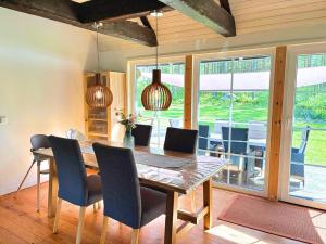 a dining room with a wooden table and chairs at Villa Yasjö in Eringsboda