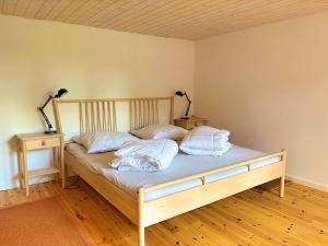 a bed with two pillows on it in a room at Villa Yasjö in Eringsboda