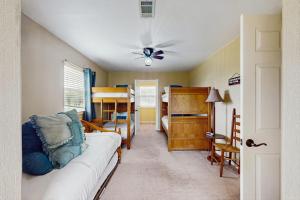 a living room with a couch and a bedroom with bunk beds at Waterfront Home with Kayak, View, Fire Pit & WiFi - Dog-Friendly in Buchanan Dam