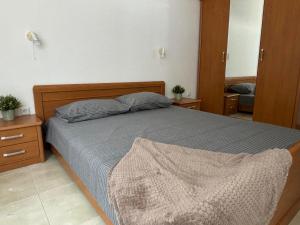 a bedroom with a bed and a mirror at Апартамент Енигма in Sveti Vlas