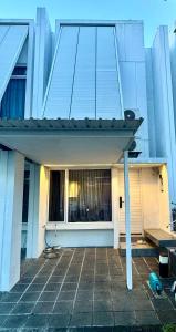 a building with a large window with a roof at Comfortable House - Tabebuya BSD in Tegal