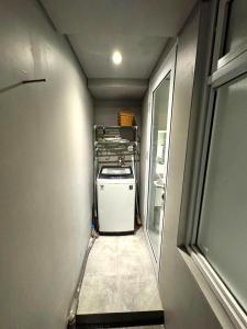 a hallway of an rv with a washer and dryer at Comfortable House - Tabebuya BSD in Tegal +4 photos
