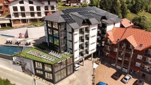 an aerial view of a building with a solar roof at Milana SPA & Hotel - SPA included in Bukovel