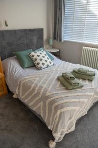 a bed with two towels on it in a bedroom at Aughamore Home in CBG
