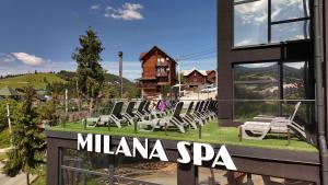 a group of chairs sitting on the side of a building at Milana SPA & Hotel - SPA included in Bukovel