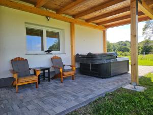 a patio with two chairs and a grill at Villa Hojnik in Videm pri Ptuju