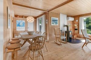 a dining room with a table and chairs at BV310-Blavand-Gronnevej-16 in Blåvand +29 photos