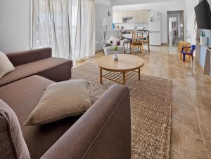 a living room with a couch and a table at Rest Studio 6 in Sotira