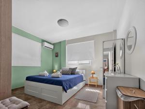 a bedroom with a blue bed and a sink at Rest Studio 6 in Sotira