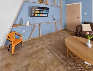 a living room with a couch and a table at Rest Studio 6 in Sotira