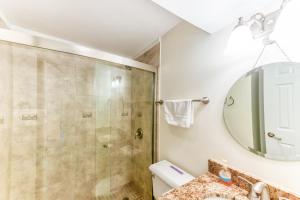 a bathroom with a shower and a sink at Charming, lakefront A-frame with private dock, lakeside gazebo, spacious deck in Bumpass +32 photos