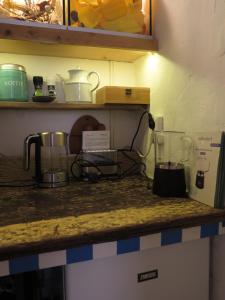 a kitchen counter with two appliances on a counter top at De Museumkamer in Den Burg +38 photos