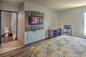 a bedroom with a bed with a television on the wall at Motel 6-Libertyville, IL in Libertyville