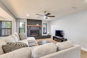 a living room with two couches and a fireplace at Pet Friendly! Canal-Front Apollo Beach Gem w/ Pool in Apollo Beach
