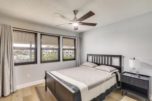 a bedroom with a bed and a ceiling fan at Pet Friendly! Canal-Front Apollo Beach Gem w/ Pool in Apollo Beach +37 photos