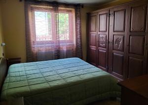 a bedroom with a bed next to a window at La Betulla in Oyace