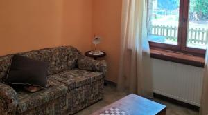 a living room with a couch with a pillow on it at La Betulla in Oyace