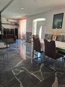 a dining room with a table and some chairs at Kameni biser in Jurdani