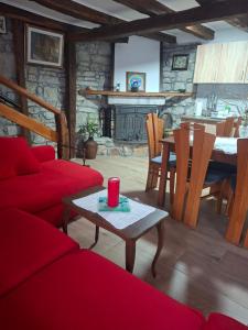 a living room with a red couch and a table at Kameni biser in Jurdani