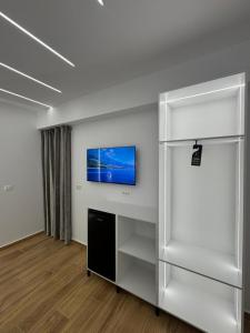 an empty room with a tv on a wall at Hotel Barjami in Sarandë