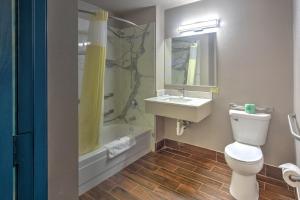 a bathroom with a toilet and a sink and a tub at Motel 6-Libertyville, IL in Libertyville +17 photos