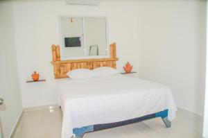 a bedroom with a bed with a mirror on the wall at Macao Sky pool suites in Punta Cana