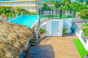 a view of a swimming pool with stairs next to a building at Macao Sky pool suites in Punta Cana