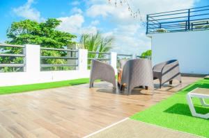 a patio with chairs and a table on a balcony at Macao Sky pool suites in Punta Cana