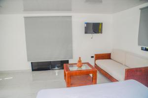 a living room with a couch and a table at Macao Sky pool suites in Punta Cana