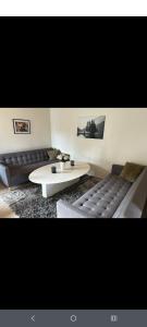 a living room with a couch and a coffee table at Skäralid, Söderåsen national park in Ljungbyhed
