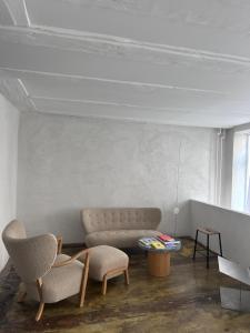 a living room with a couch and two chairs at Noura Residency City Apartment II in Copenhagen