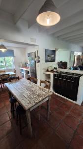 a kitchen and dining room with a wooden table and a stove at The Ark Holiday Home in Stanford