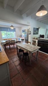 a kitchen and dining room with a table and chairs at The Ark Holiday Home in Stanford