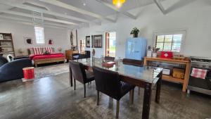 a kitchen with a dining table and a living room at 40 on Longmarket in Stanford