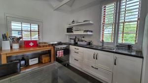 a kitchen with a stove and a sink in it at 40 on Longmarket in Stanford +47 photos