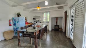 a kitchen with a dining table and a refrigerator at 40 on Longmarket in Stanford