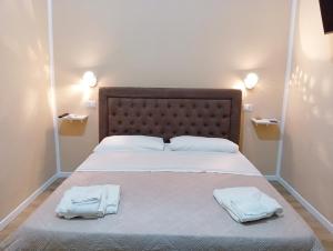 a bedroom with a bed with two towels on it at Le Suite di Antonella in Taranto