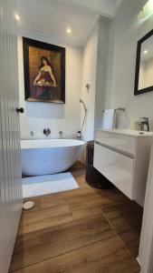 a white bathroom with a tub and a sink at Bramber cottage Stay a while in Stanford
