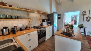 a kitchen with a sink and a stove top oven at Bramber cottage Stay a while in Stanford