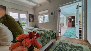 a bedroom with a bed and a vase of flowers at Bramber cottage Stay a while in Stanford