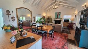 a living room with a table and a dining room at Bramber cottage Stay a while in Stanford +15 photos