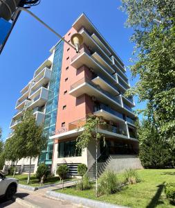 a tall red building with a street light in front of it at Sophia Luxury Residence in Mamaia